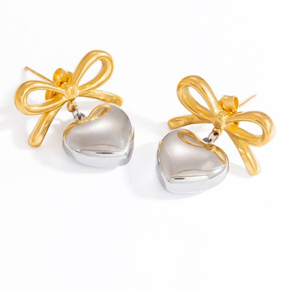 MEA NANI JEWELLERY Øredobber AMOUR BOW EARRINGS – 18K gullbelagte hjerteøredobber i kirurgisk stål